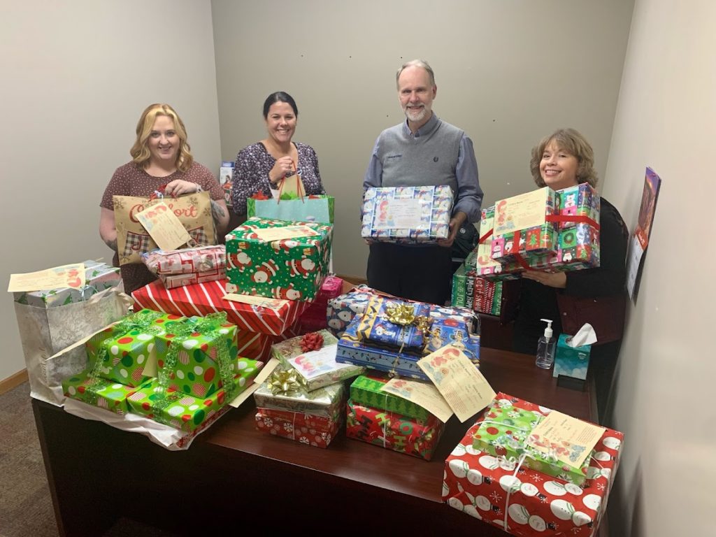 Image of Community First Bank employees with gifts donated during the holidays