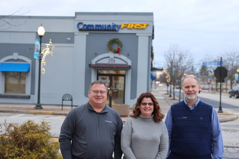 (from left) Community First Bank’s Robb Blume, Bea Wiles, and Bob Hickman outside of the bank’s headquarters in downtown Kokomo.