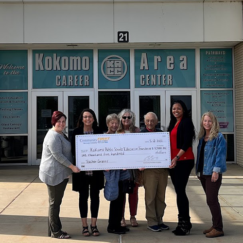 CFB employees giving a donation check to Kokomo Public Schools Education Foundation in front of the Kokomo Area Career Center.