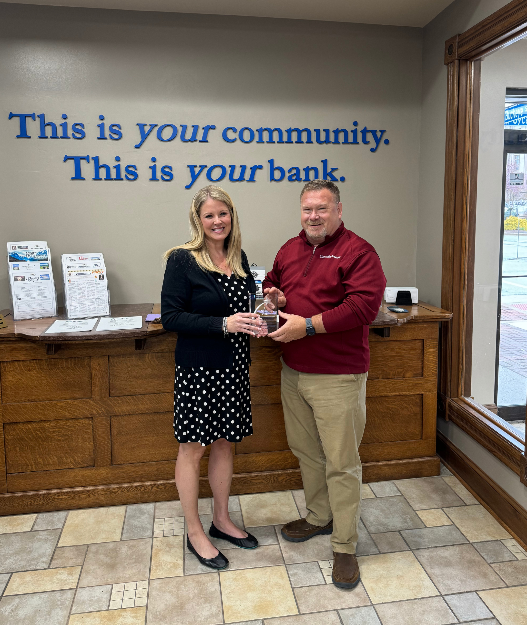 Displaying Community First Bank’s Five Star Member award from the Indiana Bankers Association are (from left): Amber Van Til/IBA President and CEO, Robb Blume/CFB President and CEO